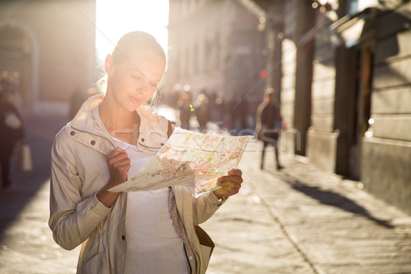 Gorgeous female tourist with a map discovering a foreign city  Stock photo © lightpoet