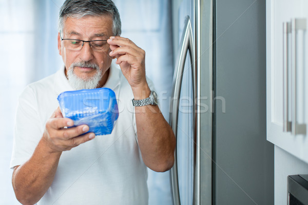 Is this still fine? Senior man in his kitchen by the fridge Stock photo © lightpoet