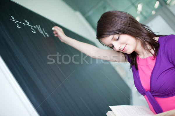pretty young college student writing on the chalkboard/blackboar Stock photo © lightpoet