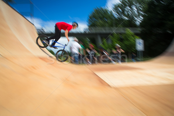 BMX Biker Performing Tricks during ride on a ramp Stock photo © lightpoet