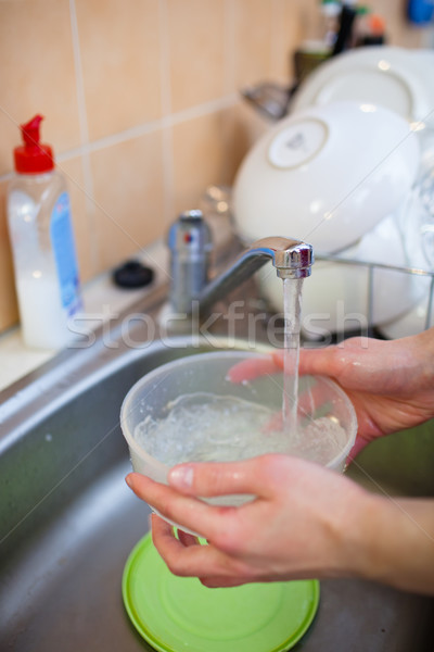  woman hands rinsing dishes under running water in the sink Stock photo © lightpoet