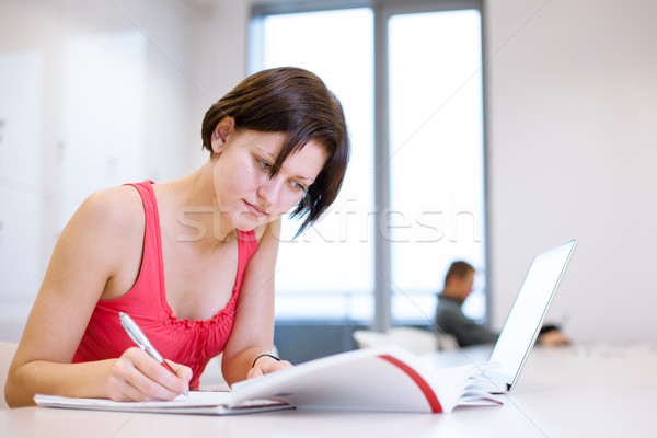 Pretty, young college student studying in the library Stock photo © lightpoet