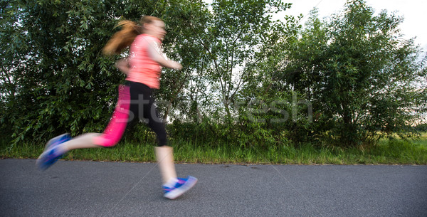 Young woman running outdoors on a lovely sunny winter/fall day Stock photo © lightpoet