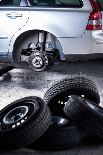 mechanic changing a wheel of a modern car (shallow DOF; color to Stock photo © lightpoet