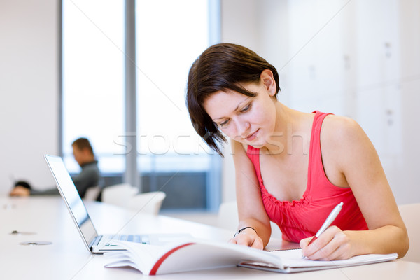 Pretty, young college student studying in the library Stock photo © lightpoet