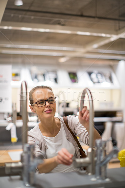 Pretty, young woman choosing the right furniture Stock photo © lightpoet