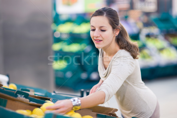 Stock photo: Pretty, young woman shopping for fruits and vegetables