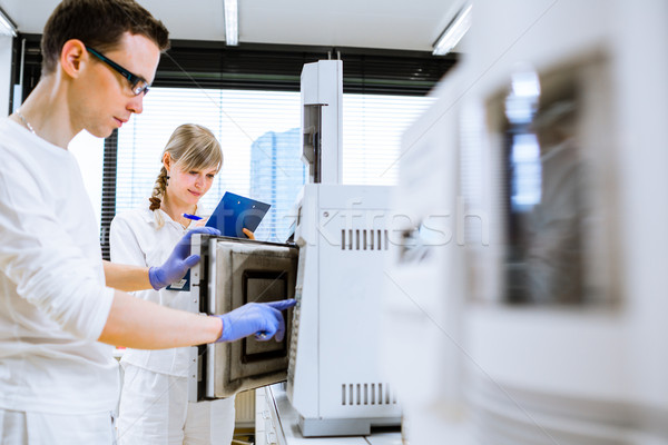 Two young researchers carrying out experiments in a lab  Stock photo © lightpoet