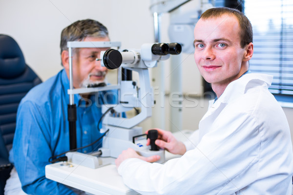 Optometry concept - senior man having his eyes examined  Stock photo © lightpoet