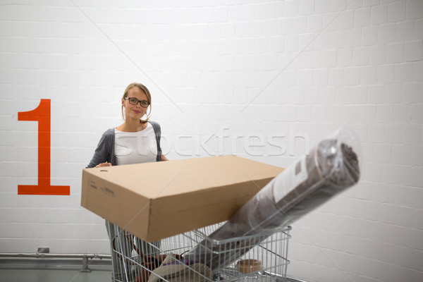 Pretty, young woman choosing the right furniture  Stock photo © lightpoet