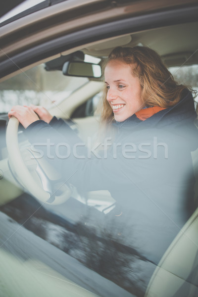 Pretty young woman driving her new car Stock photo © lightpoet