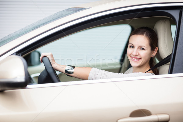 Pretty young woman driving her new car  Stock photo © lightpoet