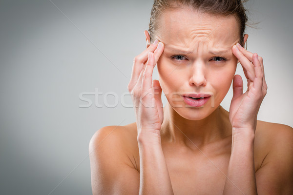 Beautiful woman suffering from acute headache  Stock photo © lightpoet