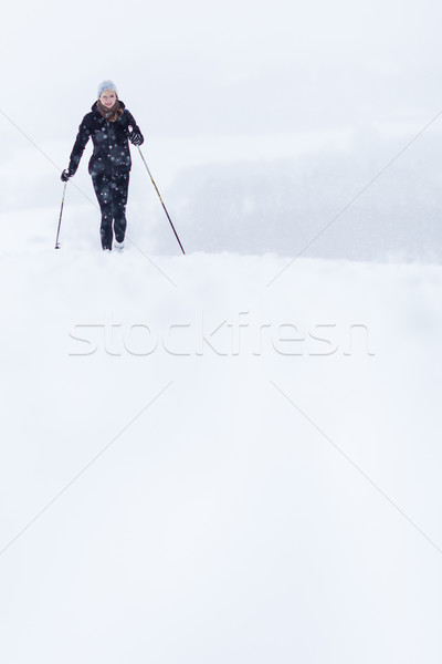 Cross-country skiing: young woman cross-country skiing  Stock photo © lightpoet
