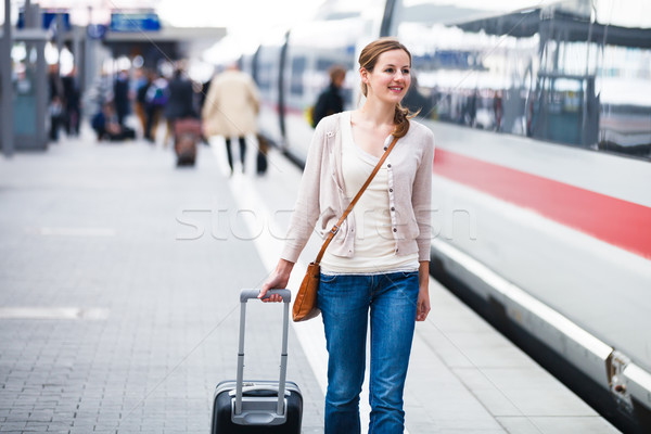 Stock photo: Pretty young woman at a train station (color toned image)