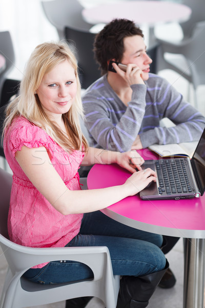 Two college students having fun studying together, using a lapto Stock photo © lightpoet