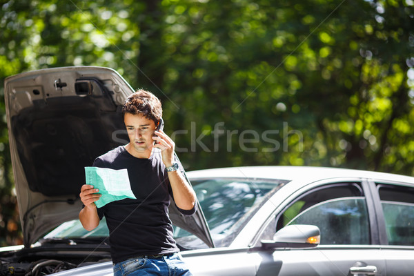 Handsome young man calling for assistance  Stock photo © lightpoet
