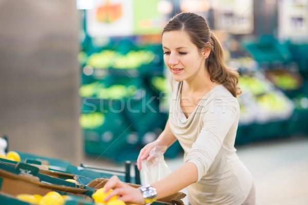 Pretty, young woman shopping for fruits and vegetables Stock photo © lightpoet