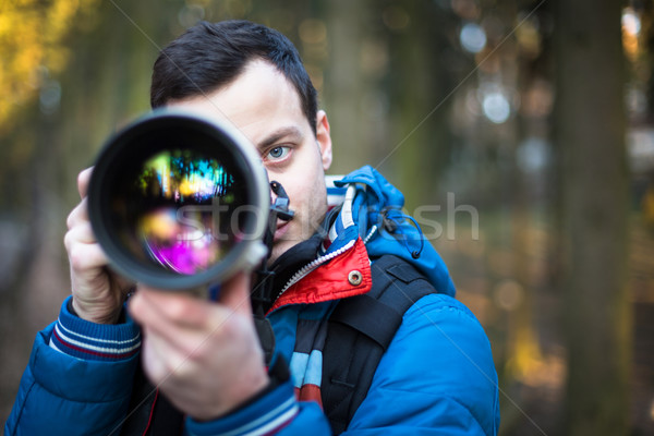 Young, male photographer taking photos Stock photo © lightpoet