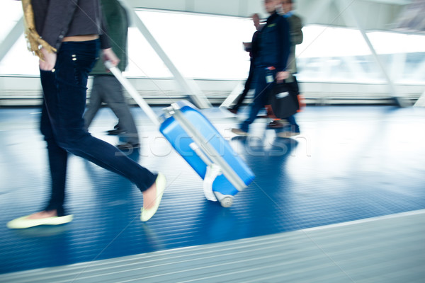 People with their suitcases walking along a corridor Stock photo © lightpoet