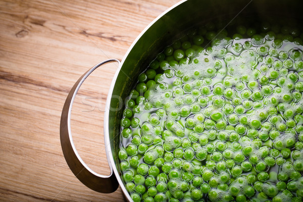 Green peas in a pot on a wooden table Stock photo © lightpoet