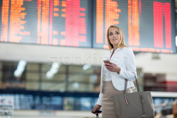 Young female passenger at the airport, using her tablet computer Stock photo © lightpoet