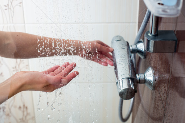 Eller genç kadın sıcak duş ev Stok fotoğraf © lightpoet