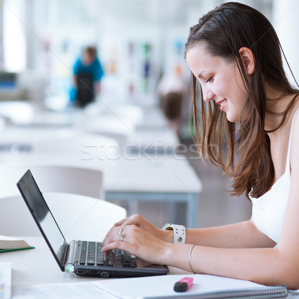 pretty female college student studying in the university library Stock photo © lightpoet