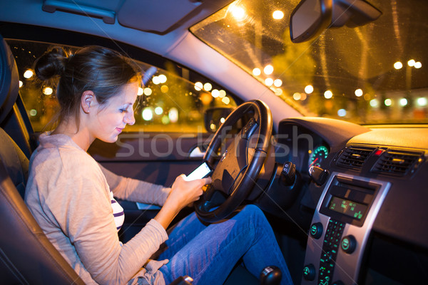 [[stock_photo]]: Joli · jeune · femme · conduite · voiture · nuit
