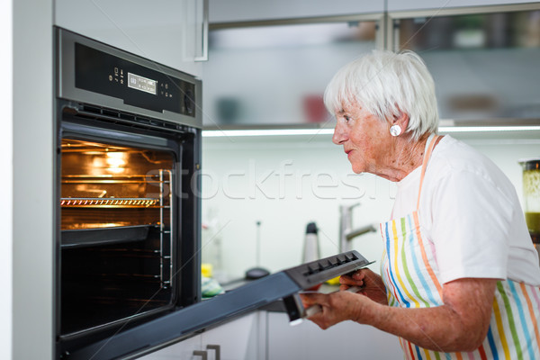 Senior woman cooking in the kitchen  Stock photo © lightpoet