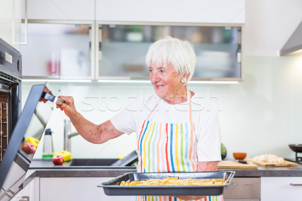 Senior woman cooking in the kitchen  Stock photo © lightpoet