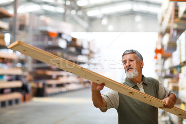 Stock photo: Man choosing and buying construction wood in a  DIY store
