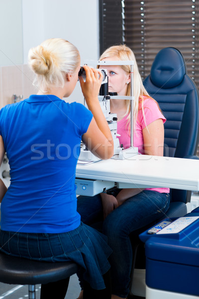 young female patient having her eyes examined by an eye doctor Stock photo © lightpoet