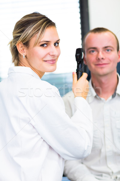 Optometry concept - handsome young man having her eyes examined  Stock photo © lightpoet