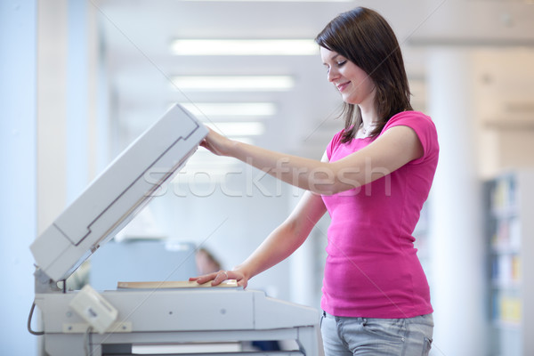 pretty young woman using a copy machine (shallow DOF; color tone Stock photo © lightpoet