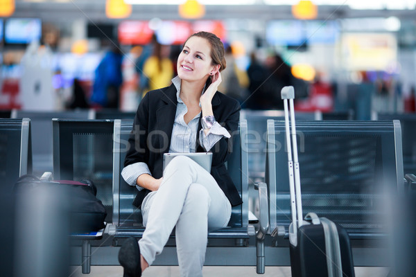 Young female passenger at the airport, using her tablet computer Stock photo © lightpoet