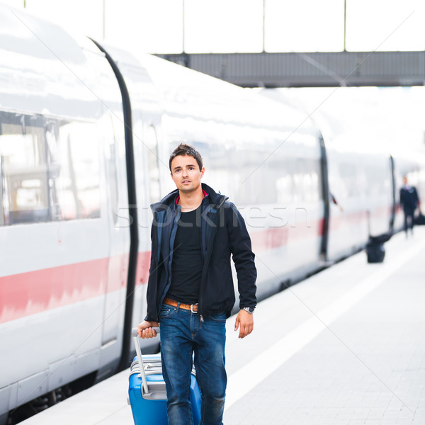 Just arrived: handsome young man walking along a platform at a m Stock photo © lightpoet