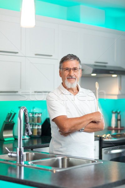 Senior man standing in his renovated, modern kitchen, Stock photo © lightpoet