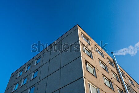 smoke/flue gases going out of a chimney by an apartment building Stock photo © lightpoet