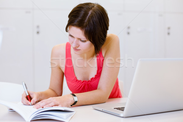 Pretty, young college student studying in the library Stock photo © lightpoet