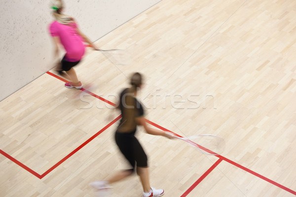 Two female squash players in fast action on a squash court Stock photo © lightpoet