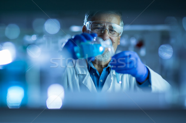 Stock photo: Senior male researcher carrying out scientific research in a lab