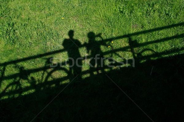 two mountain bikers' silhouettes during a halt on a bridge Stock photo © lightpoet