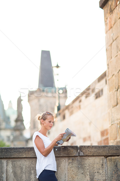 Pretty young female tourist studying a map Stock photo © lightpoet