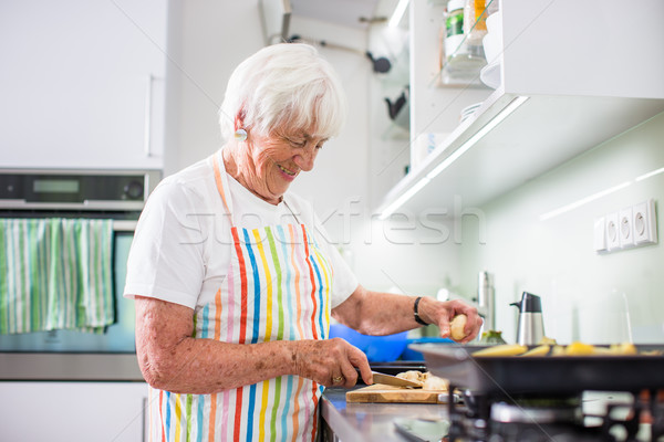 Senior woman/grandmother cooking in a modern kitchen  Stock photo © lightpoet