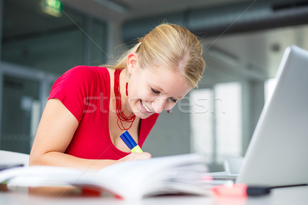 In the library - female student with books, papers and laptop Stock photo © lightpoet