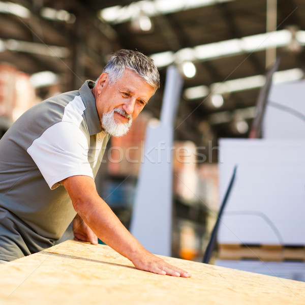 Stock photo: Man choosing and buying construction wood in a  DIY store