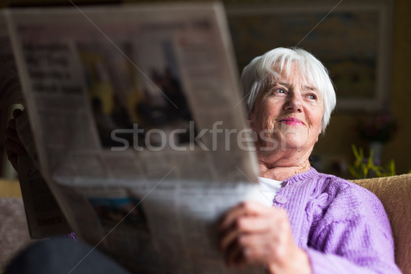 Senior woman reading morning newspaper Stock photo © lightpoet