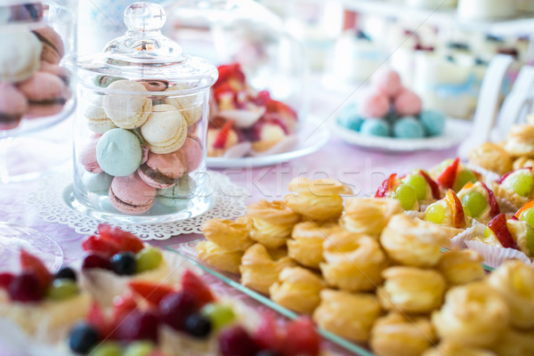 Table setting. Colorful macarons and cakes. Stock photo © lightpoet