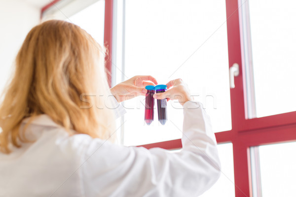 Young female scientist works in modern chemistry/biology lab (sh Stock photo © lightpoet